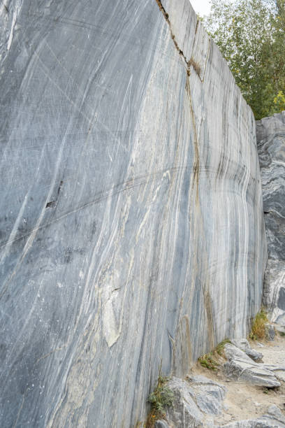 istock The marble quarry features smooth, polished stone surfaces with natural markings under bright sunlight surrounded by greenery 2173270083