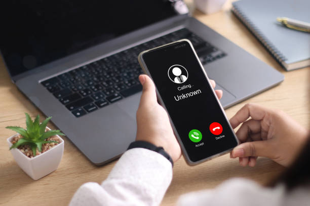 istock Unknown number displayed showing on smart mobile phone. Human use smartphone with incoming call from unknown number, spam, hacker, call center, crime, 2173274977