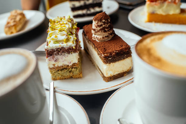 Delicious cakes and cappuccino for breakfast on a table in a cafe