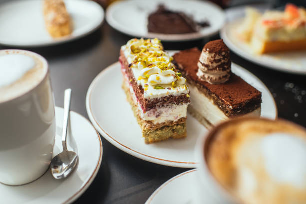Delicious cakes and cappuccino for breakfast on a table in a cafe