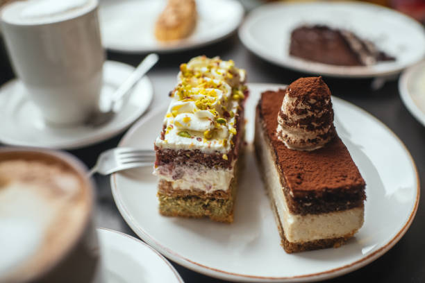 istock Delicious cakes and cappuccino on a table in a cafe 2173276223