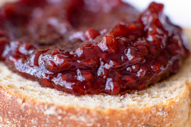 istock Red fruit jelly on a slice of bread 2173278494