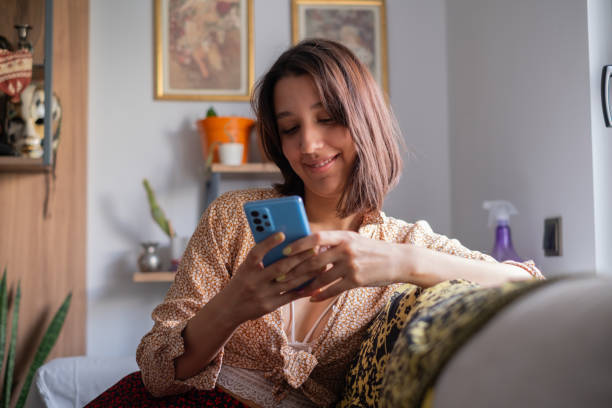 istock Young Woman Using Smartphone at Home 2173278510