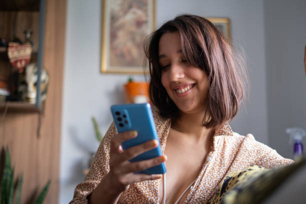 istock Young Woman Using Smartphone at Home 2173278531