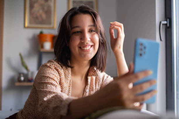 istock Young Woman Using Smartphone at Home 2173278534