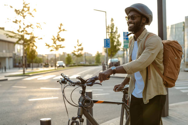 istock Commuter walking with bicycle on sunny urban sidewalk 2173280618