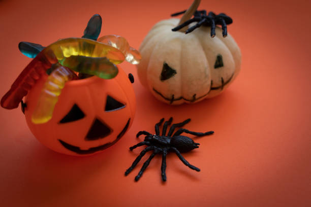 Halloween pumpkin jack o lantern decor with funny faces on orange background