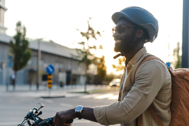 istock Commuter walking with bicycle on sunny urban sidewalk 2173281300