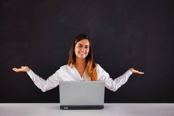 Woman thinking next to a blackboard