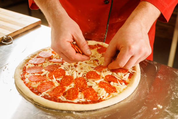 istock Chef preparing a pepperoni pizza in the kitchen 2173282008