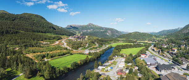 A stunning aerial view of the city of Hemsedal, Norway. Surrounded by lush greenery and dramatic peaks, this picturesque scene captures the natural beauty of the Norwegian landscape.