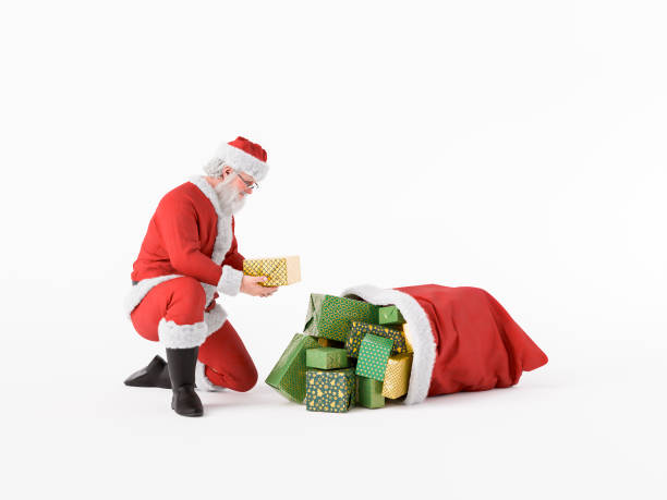 istock Santa Claus picking up a Christmas present from his full sack 2173290824
