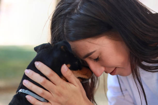 istock Woman gently touching foreheads with her small dog 2173292027