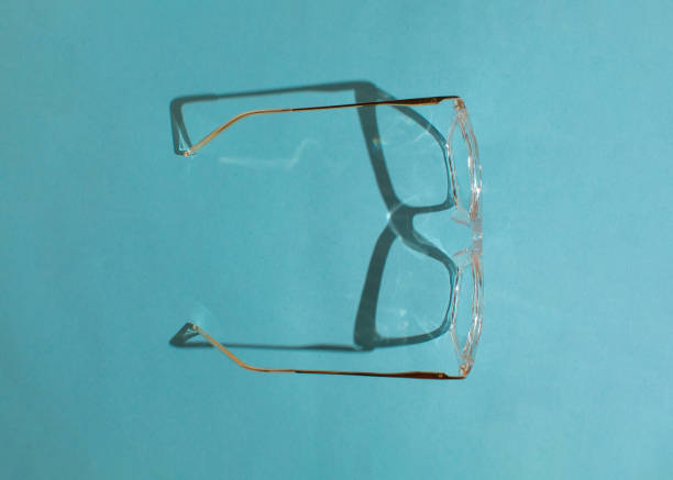 istock Transparent glasses on blue background. Minimal creative concept. Flat lay. 2173292073