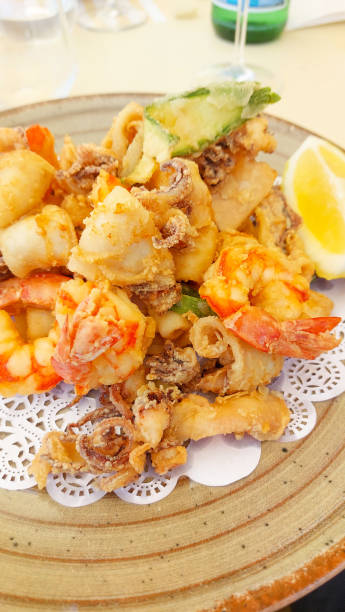 istock Plate of freshly fried seafood is served on a table 2173292886