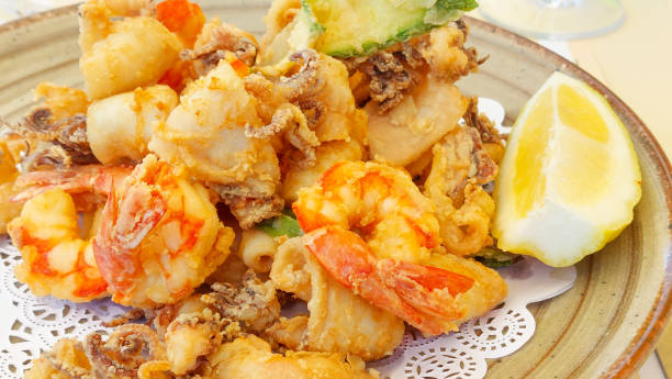 istock Plate presenting a delicious meal of various deep fried seafood with a lemon slice 2173293139
