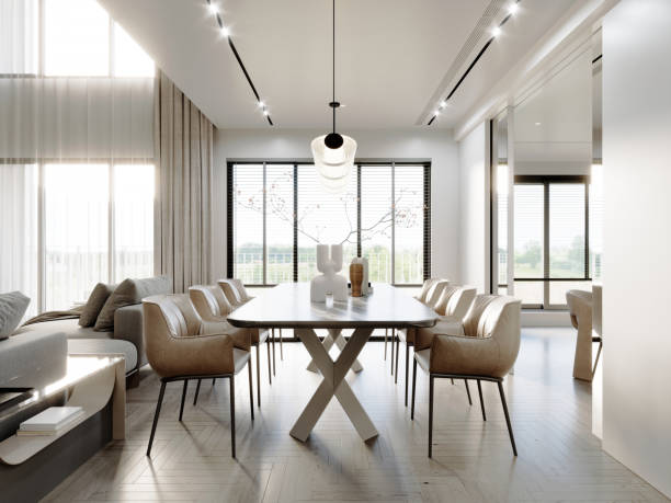 istock Bright dining area with natural light, beige leather chairs, modern table, elegant pendant light, and large windows in a sophisticated open-plan layout 2173294321