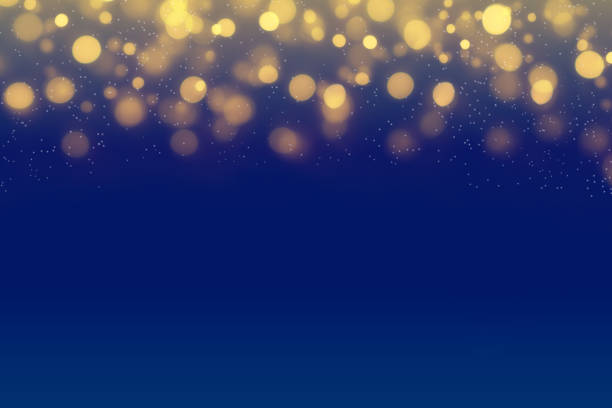 Christmas lights on blue night background with golden bokeh