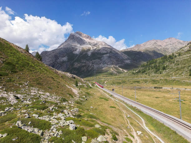 istock Red Train Passing Through Scenic Mountain Landscape 2173297902
