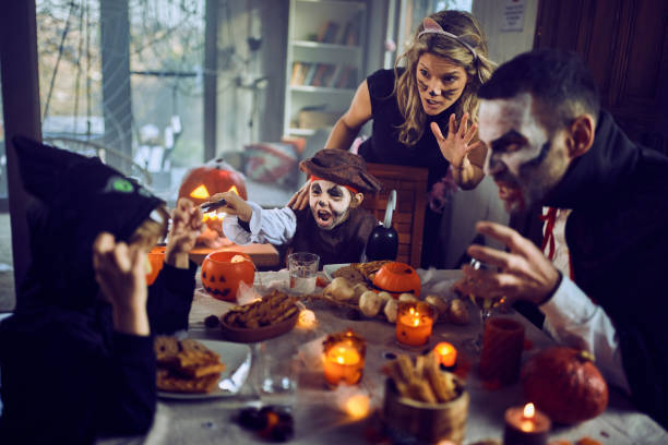 istock Carefree family having fun on Halloween at dining table. 2173301807