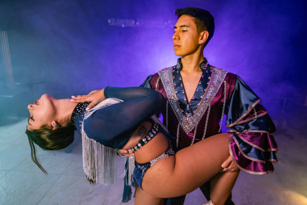 Young couple dancing salsa in a ballroom