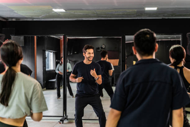 Teacher and students rehearsing in a dance studio