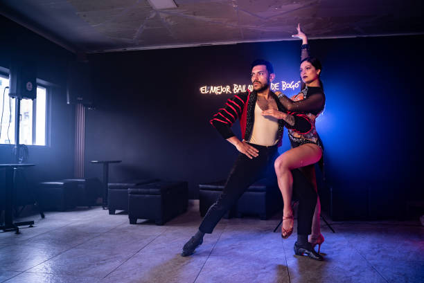 Young couple dancing salsa in a ballroom