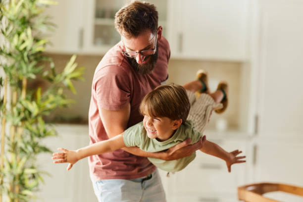 istock Playful father having fun with his small son at home. 2173306190