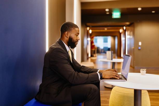 istock Side view of a black businessman working on his laptop 2173306665