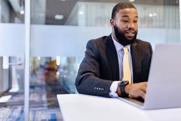 istock Close-up of a man typing on a laptop while working 2173306896