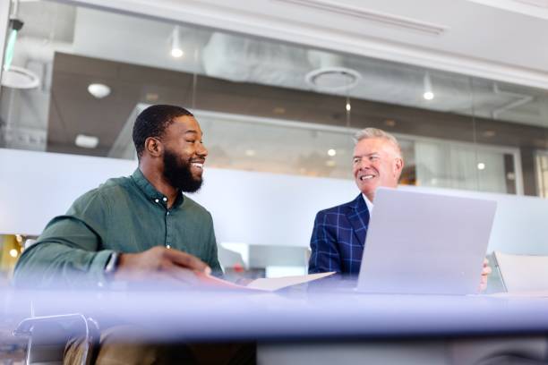 istock Smiling men working in the modern office 2173307099
