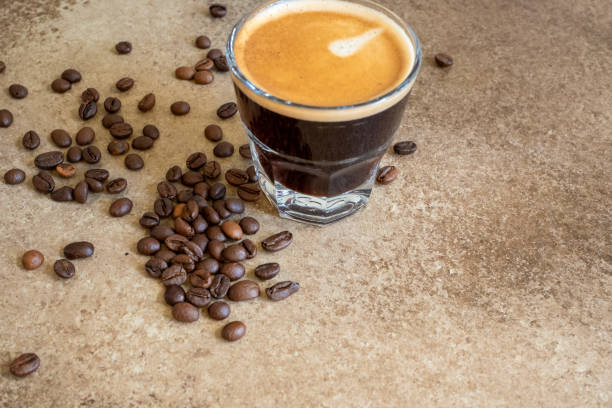 istock coffee beans on brown background and a cup of espresso coffee 2173311614