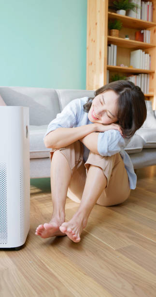 istock woman use air purifier home 2173313696