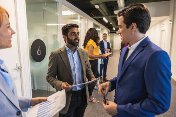 istock Multiracial Business Team Discussing Documents in Office Hallway 2173316096