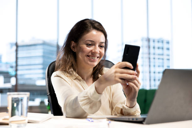 istock Young empowered business entrepreneur texting messages on her work break 2173316146