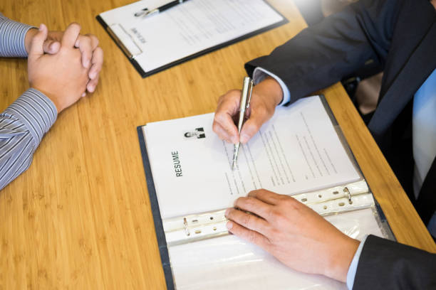 high angle view of man writing in resume on table