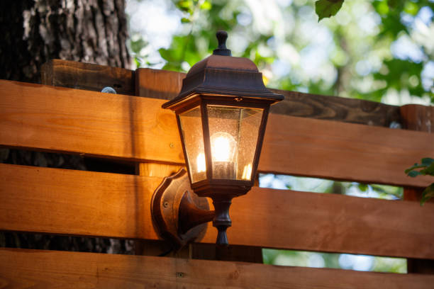 istock A lighted lamp post is on a wooden fence 2173318784