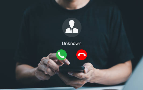 istock Fraud and phishing concept. Man holding mobile phone with incoming call from unknown caller. scammer or stranger, Hoax person with fake identity, Prank caller, anonymous, smartphone, unwanted, spam, 2173322419