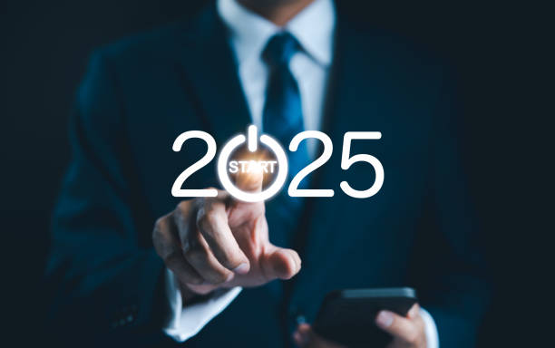 istock 2025 start button press concept. Businessman presses digital start button integrated into the year 2025, symbolizing beginning of new opportunities, projects, and business ventures for upcoming year. 2173322450