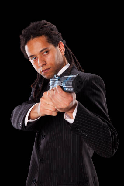 istock Powerful rastafari businessman aiming a handgun 2173324269