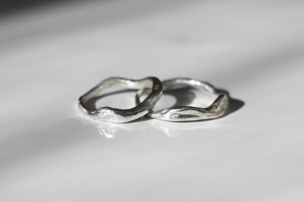 istock Two unique silver rings free form elegantly displayed on smooth white surface. Handmade jewelry. 2173324780