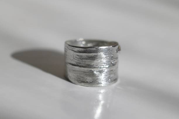 istock Minimalist silver ring with a textured surface on a white background. Handcraft precious item. Jewelry accessories. 2173324891