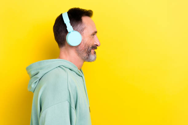 istock Side profile photo of cheerful handsome guy dressed mint sweatshirt headphones look empty space isolated on yellow color background 2173326847