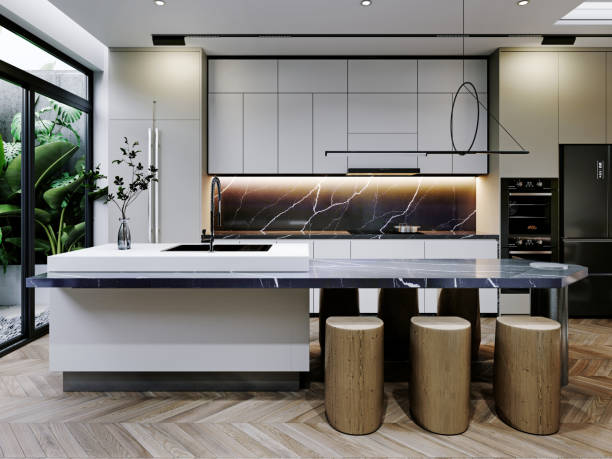 istock Contemporary kitchen with a large island, wood stools, and a striking marble backsplash. Floor-to-ceiling windows bring natural light, enhancing the sleek, modern design. 2173327469