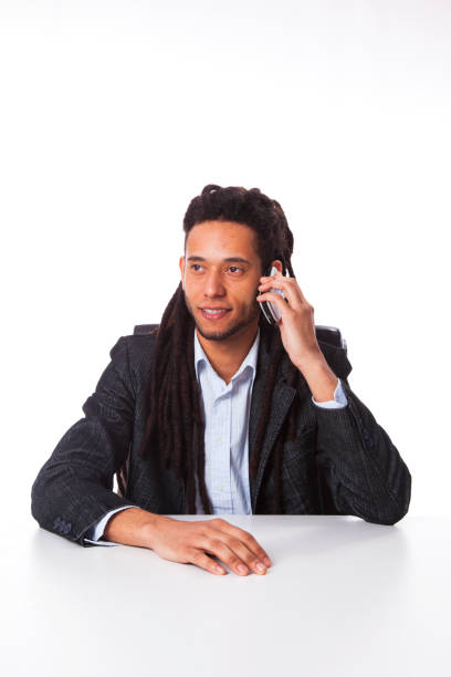 rastafari man holding the cell phone at his office