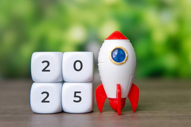 istock A toy rocket placed next to a white dice with number 2025. 2173329095