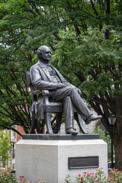 Baltimore, USA - July 21, 2024. The bronze statue of George Peabody sculpted by William Wetmore Story in the east garden of Mount Vernon Place in Baltimore, Maryland, USA