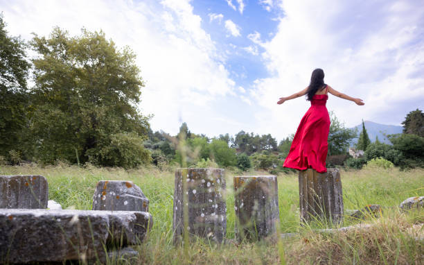 Young woman admiring an ancient greek ruins in Thassos.
