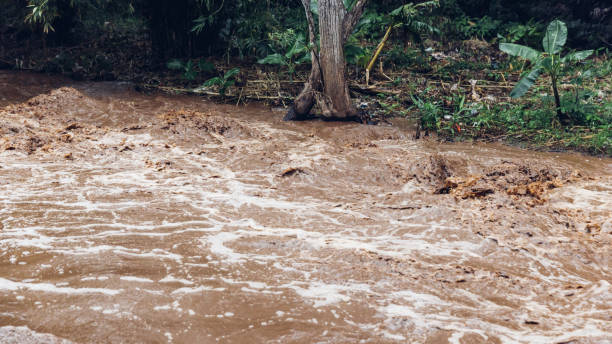Flash flood, flood waters rushing down the river after the storm flows through.