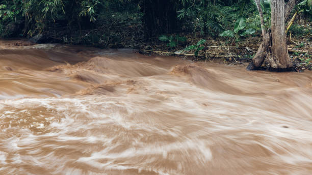 istock Flash flood, flood waters rushing down the river after the storm flows through. 2173340559